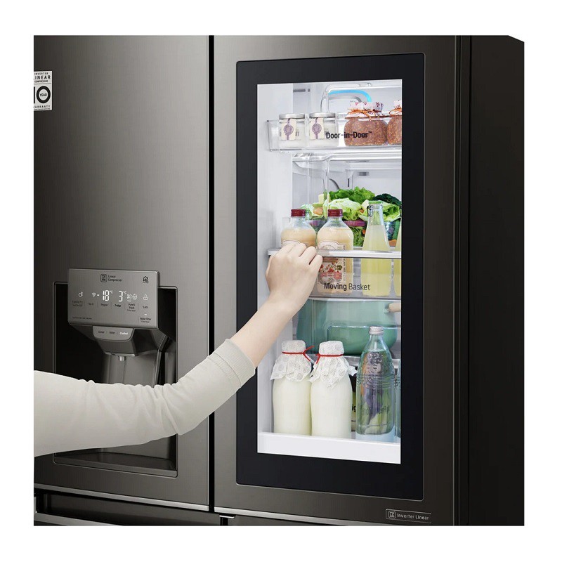 A person taking a drink out of a refrigerator Description automatically generated